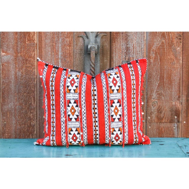 This stunning pillow cover is made with hand-woven Moroccan Berber. It is embellished with intricate vintage embroidery...
