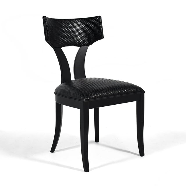 These stylish side chairs by Pietro Costantini have shapely black frames and seats upholstered in woven leather.