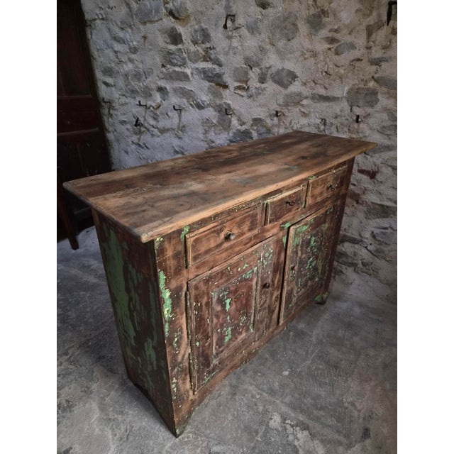 This French buffet dates from the 18th century and is made of solid walnut. The cabinet features three drawers above two...