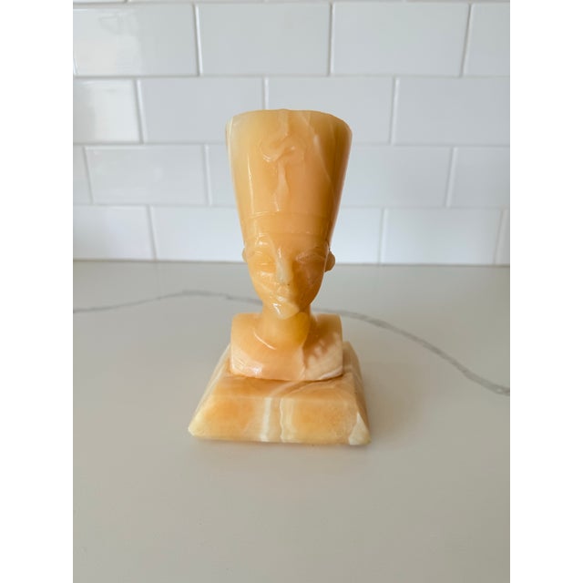 This striking vintage bust depicts Queen Nefertiti, one of ancient Egypt's most iconic figures, hand-carved from richly...