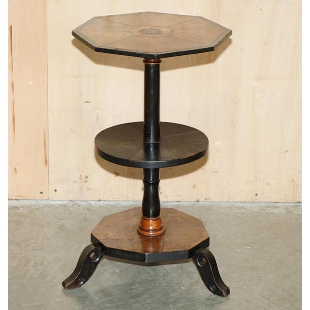 This sublime victorian circa 1860-1880, hexagonal burr walnut split paneled three tier side table please note the delivery...