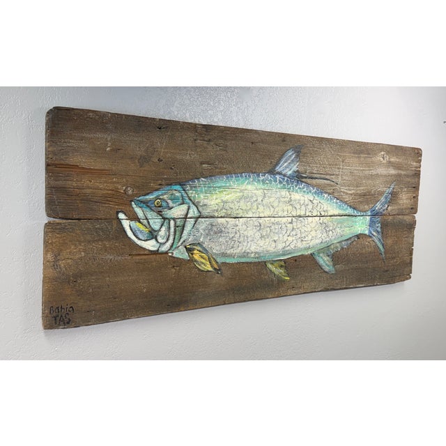 Original art on rustic salvaged planks depicts an Atlantic Tarpon in the signature greenish-blue back blending into...