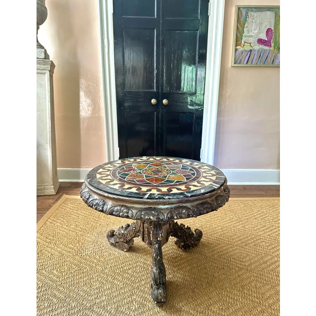 A gorgeous carved and silvered gilt wood Italian Grotto styled occasional table having a spectacular pietra dura marble...