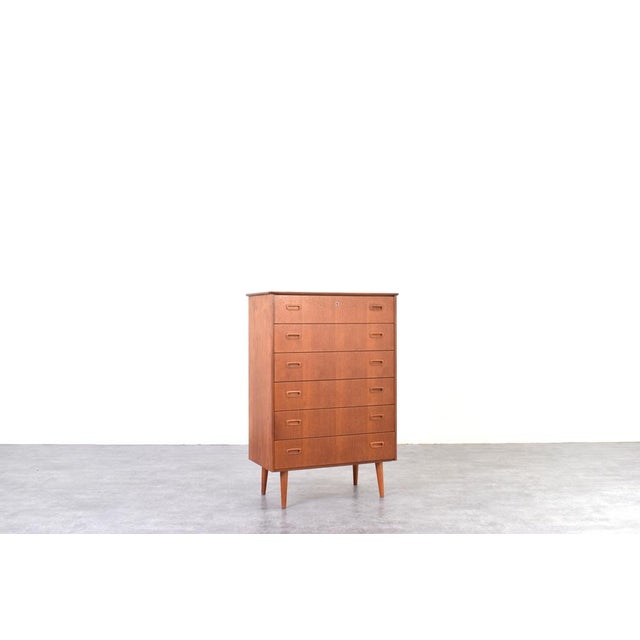 This teak chest of drawers was manufactured in Denmark in the 1960s. The furniture has been professionally and carefully...