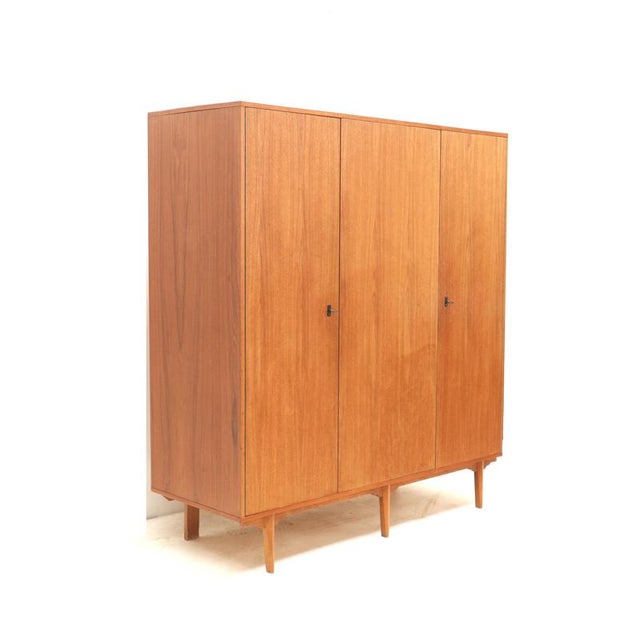 Vintage Belgian design 3-door wardrobe made in the 1960s. This vintage 3-door wardrobe from the 1960s is a beautiful...