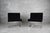 A pair of mid-century cantilever black lounge chairs, designed in the 1970s. The design showcases an ability to blend a...