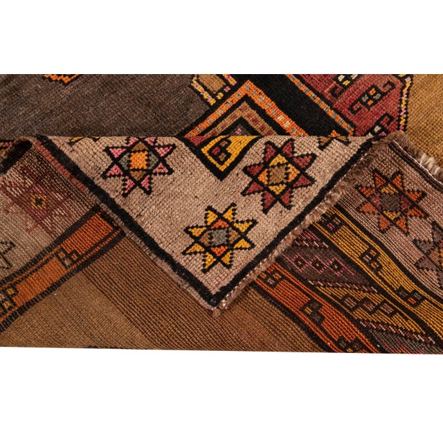 A hand-knotted vintage Azeri runner with an artistic design on a tan field. This piece has multi-color accents throughout...