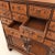 A Korean apothecary chest with sixteen small drawers above a two-door cupboard. Chests like this were made for village...