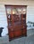 1980's vintage traditional mahogany wood China cabinet. Bottom has a cabinet, single door and a drawer. upper has a glass...