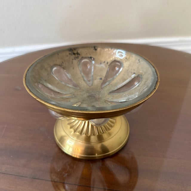 Add a touch of vintage elegance to your decor with this stunning brass compote dish. Featuring a fluted pedestal base and...