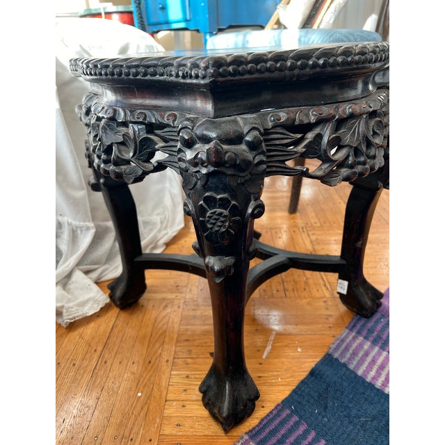 Antique Chinese cavred rosewood or mahogany plant stand/side table with ornate hand-carved details. This table likely...