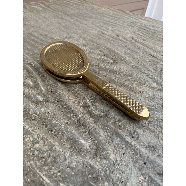 A beautiful cast brass door knocker in the form of a tennis racket. USA, Late-20th Century Measures: 2.5"W x 1.38"D x 8"H....
