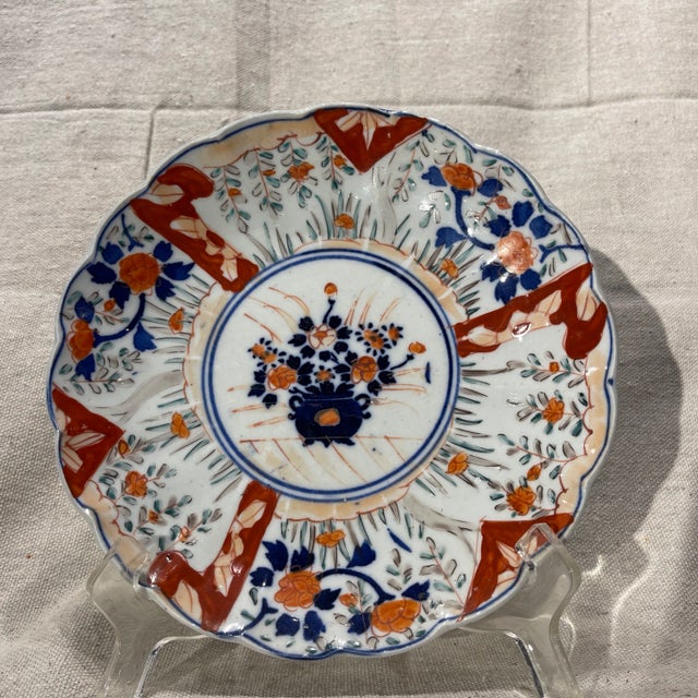 A fine 19th Century hand painted Japanese Imari plate with a lovely scalloped edge. Central cobalt blue double handled...