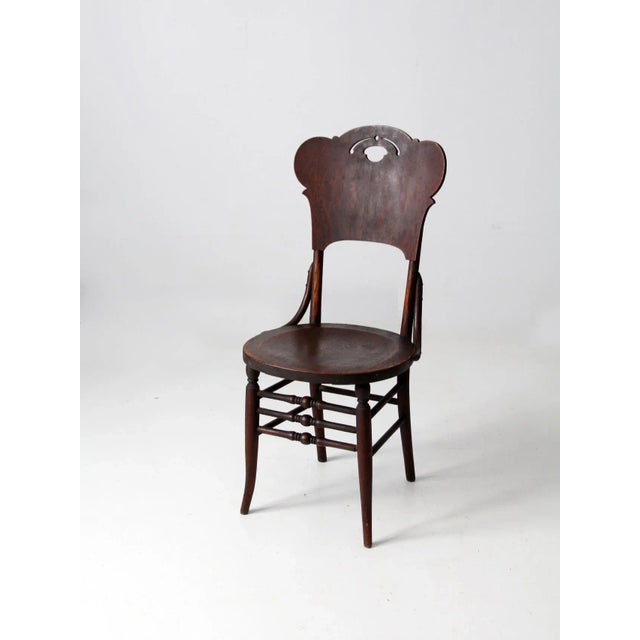 This is an exceptional antique bentwood chair. The timeless wooden dining chair features a round seat, triple turned...