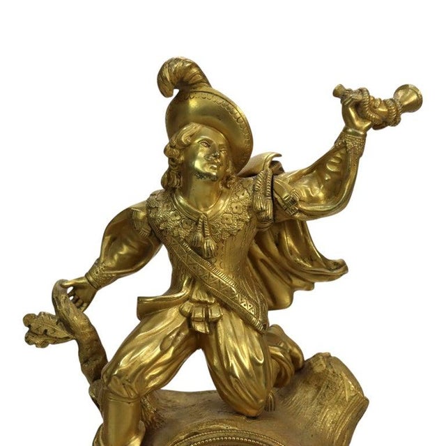 An antique French Empire mantel clock in gilt bronze, circa 1830, with a cast figural group above a stepped architectural...