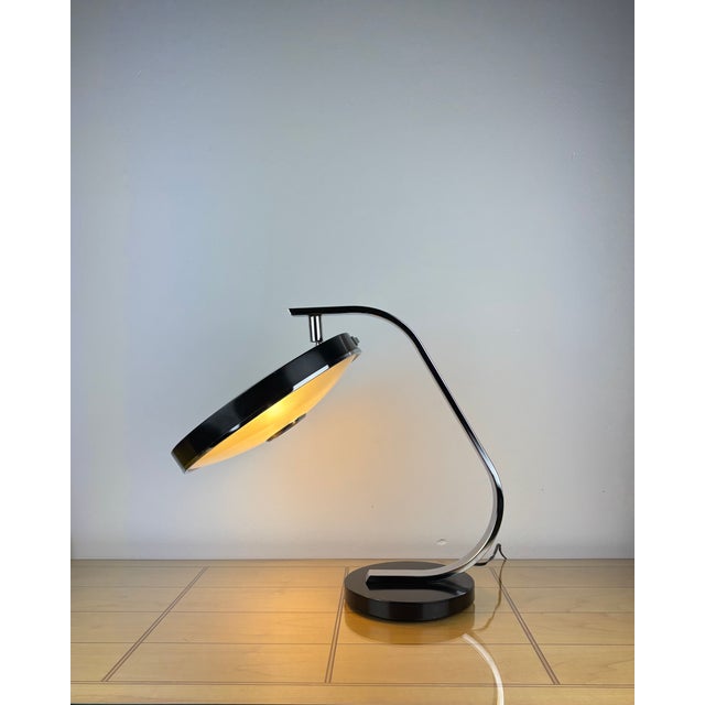 The fase 520c is an elegant, sculptural table lamp from spain’s mid-century production, notable for its low-profile saucer...