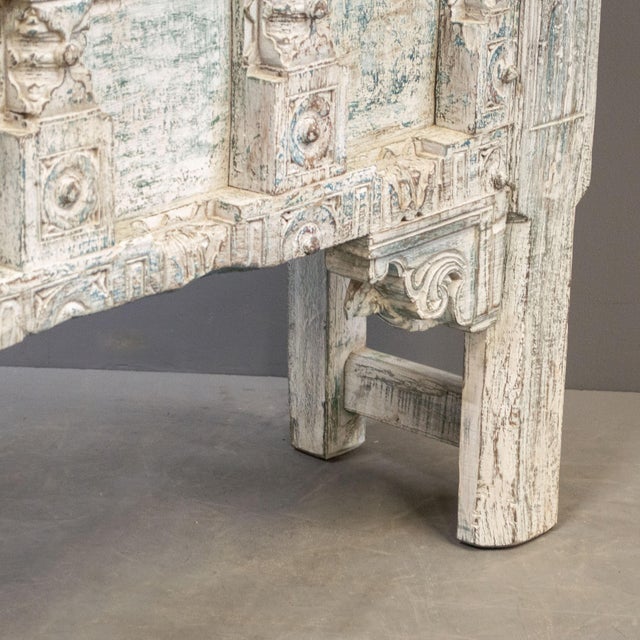 This painted teak table from India features an antique Rajasthani door with floral carvings and metal strapping,...