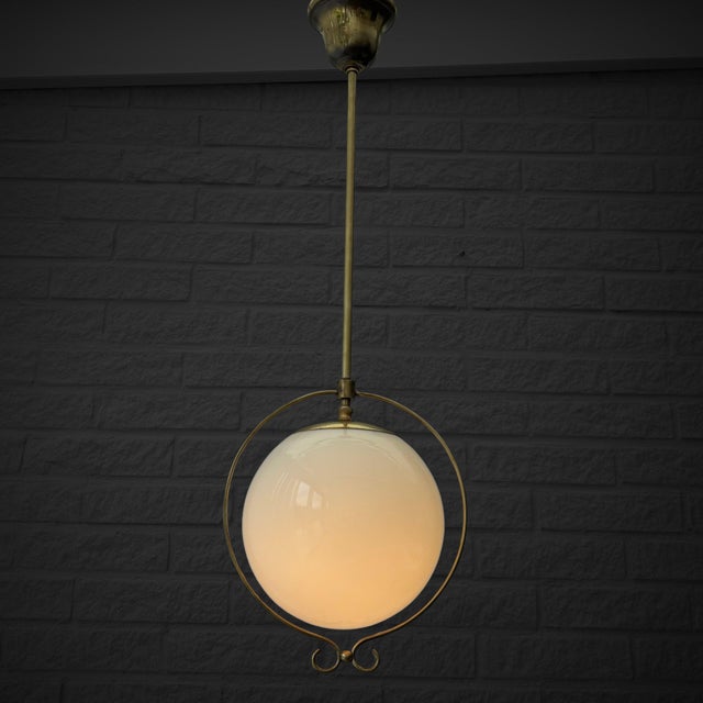 A functionalist globe pendant lamp produced by an unidentified Swedish manufacturer in the 1930s. This elegant design...
