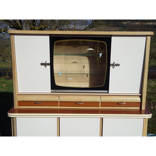Two-piece kitchen buffet by Weiler, made in Alsace, France, in the 1960s. Lower section: three-door sideboard on wooden...
