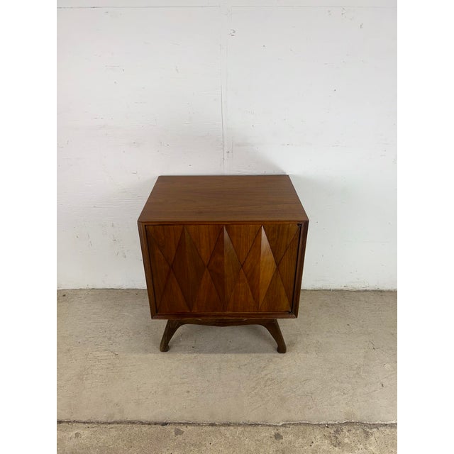 This mid century modern nightstand by Albert Parvin for American of Martinsville features hardwood construction, walnut...