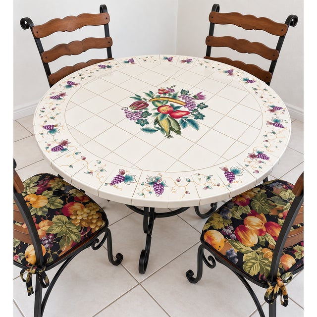 Charming vintage five-piece dining set featuring a round tiled tabletop with an elaborate fruit and grape motif, paired...