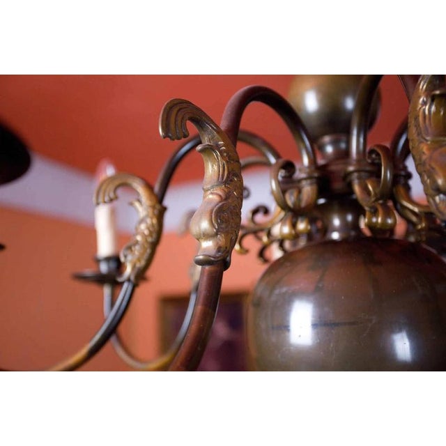 Eight-armed dutch chandelier decorated with fish. Patinated brass. The chandelier is for classic candle bulbs with an e14...