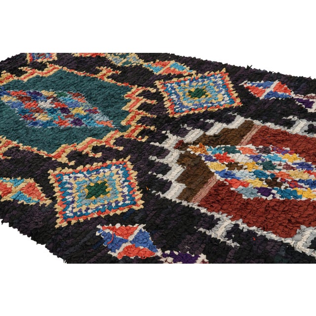 Hand-knotted in wool and originating from Morocco circa 1950-1960, this 5x8 vintage Moroccan rug is an extremely rare...