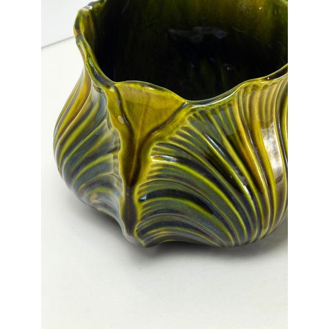 A late Victorian ceramic shell jardiniere designed by Christopher Dresser and manufactured by Ault Pottery circa 1890....