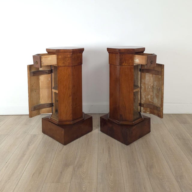 A pair of early 19th-century column cabinets in cherry, Italy circa 1820.