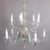 Oversized European crystal chandelier features pressed glass bodice and ten scroll arms terminating in candle lights, cut-...