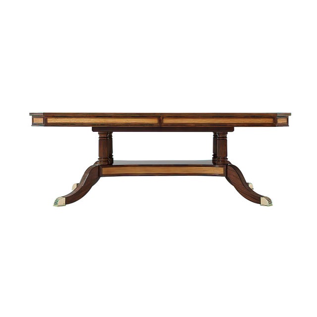 Mahogany and figured mahogany veneered and crossbanded extending dining table, the rectangular top opening to accommodate...