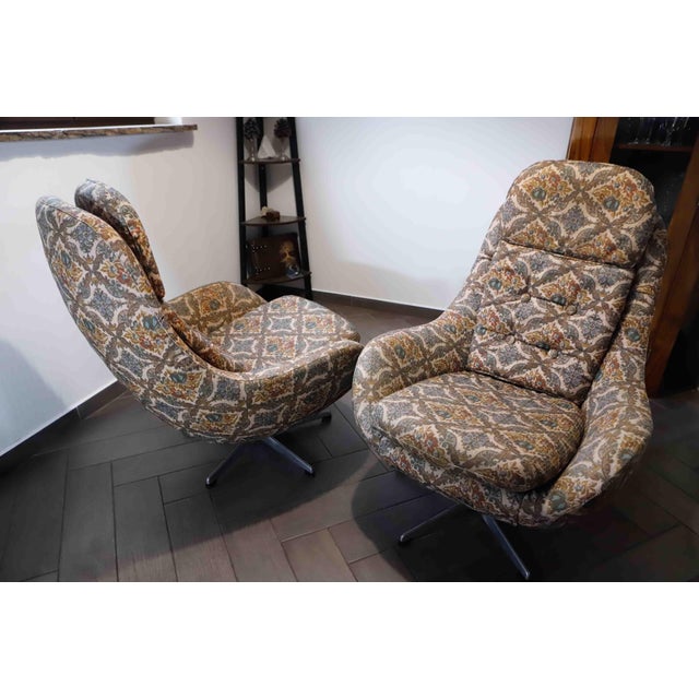 This distinctive pair of high-back swivel lounge armchairs was manufactured in Czechoslovakia by UP Závody Rousínov during...