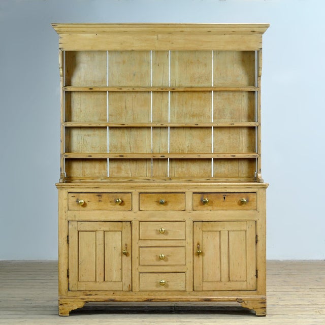 This 19th-century pine buffet cabinet exudes timeless elegance and artisanal craftsmanship. The upper cabinet features...