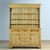 This 19th-century pine buffet cabinet exudes timeless elegance and artisanal craftsmanship. The upper cabinet features...