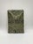 A wall object / art object * Wall panel made of ceramic * A face in the center of an organic-looking structure, an entire...