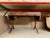 A drop-leaf table on casters. It has two long drawers on the front. There is a key included. It has two leaves that drop...