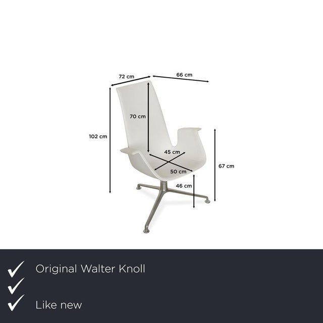The FK armchair by Walter Knoll is upholstered in white genuine leather and stands on a tripod base. The shell chair is...