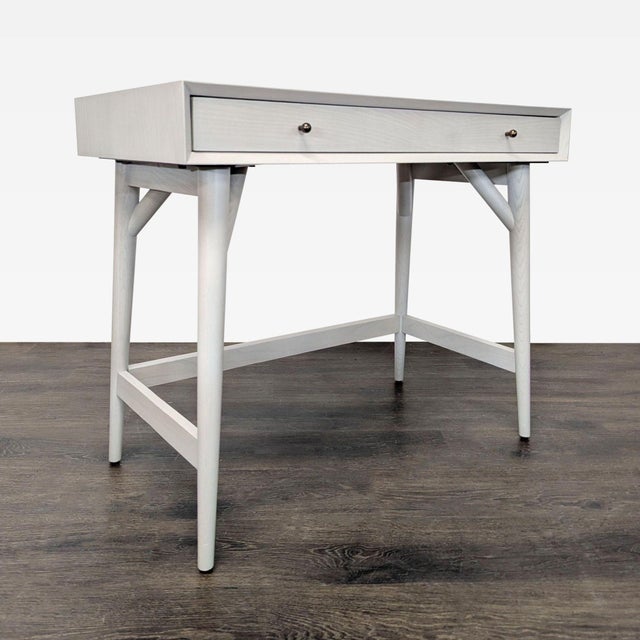 This West Elm desk features a sleek finish and a sturdy wood frame. It has a spacious single drawer for convenient storage...