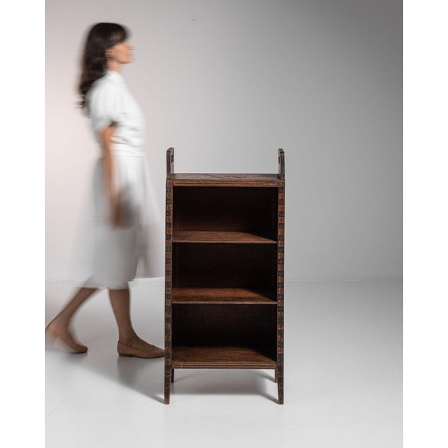 Open oak bookshelf in Weathered Dark Oak. The weathered dark oak surface highlights three open shelves, simple square...