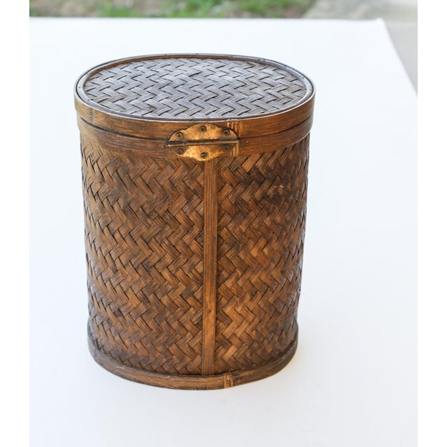 A Tropical Tiki style medium-sized oval storage basket, late 1990s Asian import style. Lightweight dark brown bamboo...