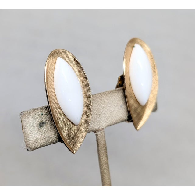 1950s ellipse with point at the bottom goldtone Florentine finish with white resin marquise rhinestone clip earrings....