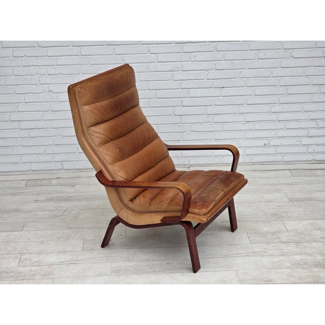 1970s, Scandinavian highback armchair. Original light brown furniture leather with patina, bent beech wood. Original good...