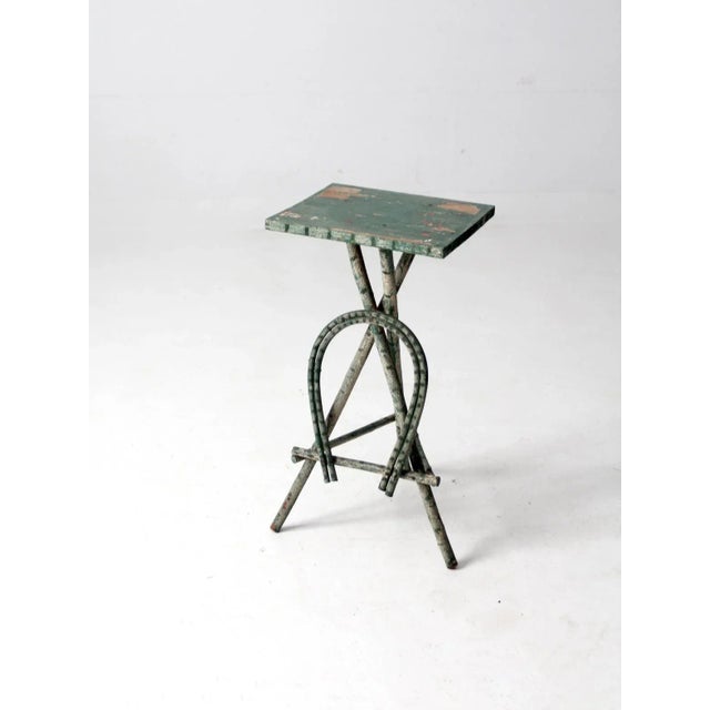 This is an antique Adirondack style twig table. This warm and textured side table with its worn green and white paint from...