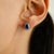 This timeless stud earrings features 2 oval cut natural blue sapphires totaling 1 carat set in 14K white gold. Each...