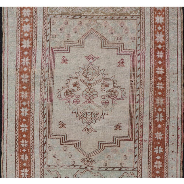 Measures: 3'4 x 5'4 Hand-knotted in Turkey during the 1940's, this vintage Oushak features a great medallion and layer...