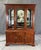 This vintage Ethan Allen Georgian Court china cabinet and buffet is crafted from solid cherry and features a stately two-...