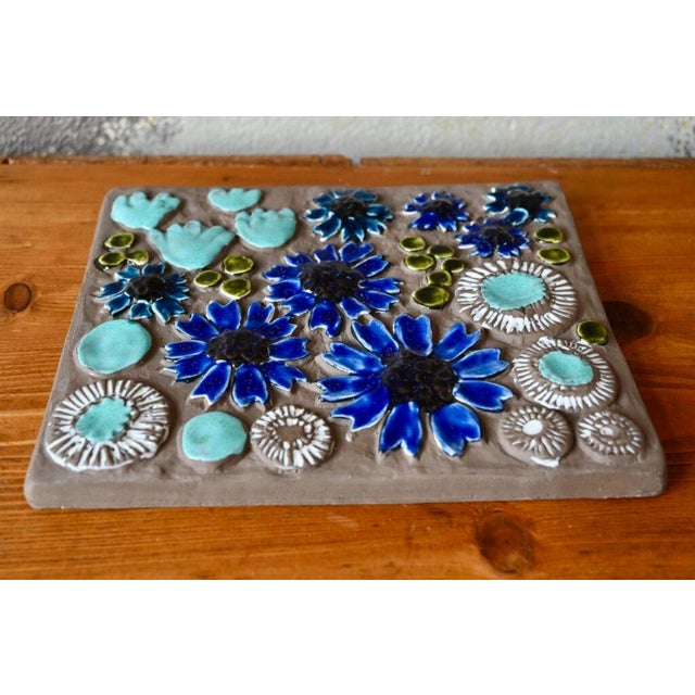 A colorful, bohemian ceramic plaque, this typically Swedish wall decoration was produced by Jie Gantofta, a Scandinavian...