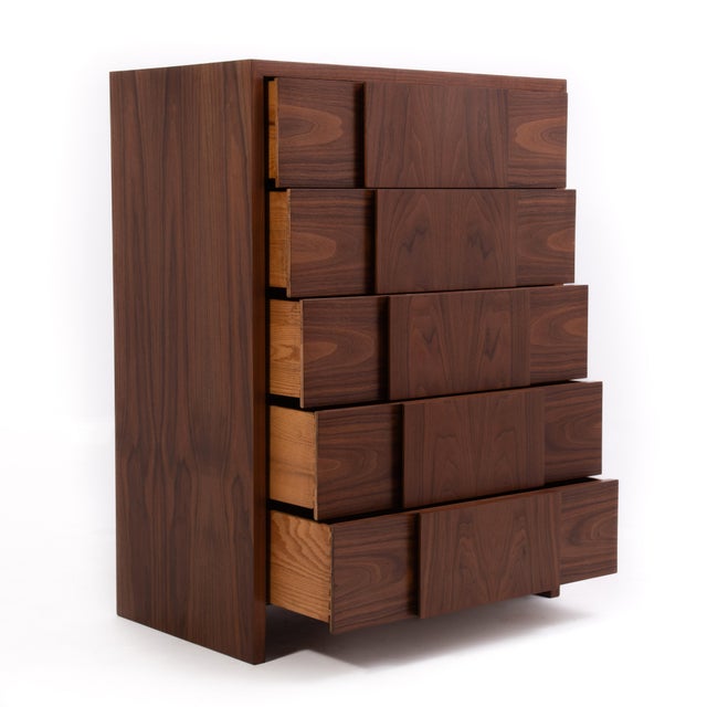 An absolutely stunning tall chest designed by Dale Ford for the Widdicomb Furniture Company. Circa 1950s. The walnut grain...