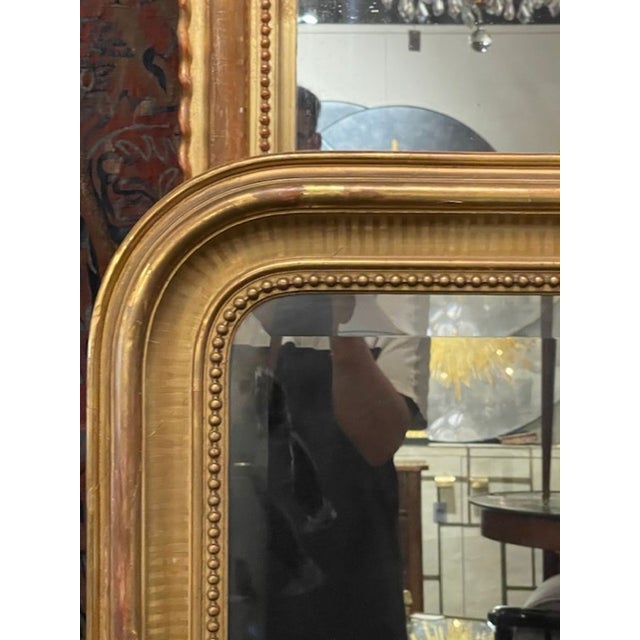 The 19th c. French Louis Philippe Mirror with Line Pattern Frame is an antique piece of home décor that exudes elegance...