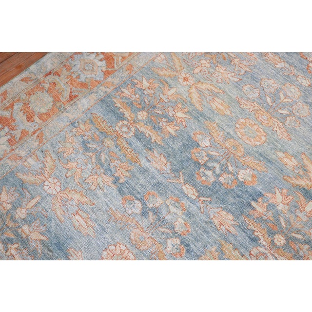 An early 20th century Persian Mahal Gallery size rug in light blue, light green, and an orange terracotta border color...